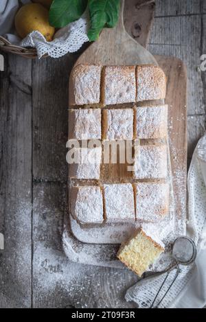 Top view of wooden board with Pasiego cake a typical cake from Catalonia in Spain sprinkled with sugar on rustic wooden table Stock Photo