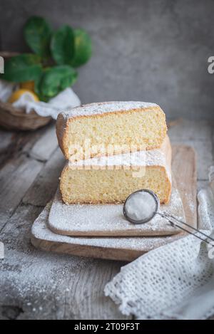 From above wooden board with Pasiego cake a typical cake from Catalonia in Spain sprinkled with sugar on rustic wooden table Stock Photo