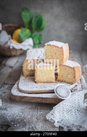 From above wooden board with Pasiego cake a typical cake from Catalonia in Spain sprinkled with sugar on rustic wooden table Stock Photo