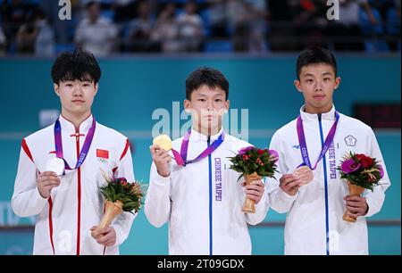 Hangzhou, China's Zhejiang Province. 5th Oct, 2023. Gold Medalist Wang Yu-Chun (C) of Chinese Taipei, Silver Medalist Zhang Hao (L) of China and Bronze Medalist Huang Pin-Ruei of Chinese Taipei attend the awarding ceremony for Men's Inline Freestyle Skating Speed Slalom at the 19th Asian Games in Hangzhou, east China's Zhejiang Province, Oct. 5, 2023. Credit: Chen Yehua/Xinhua/Alamy Live News Stock Photo