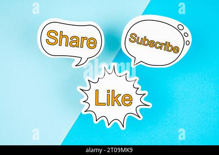 Like, Subscribe and Share text on speech bubble on the blue color background. Stock Photo