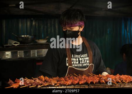Chiang Rai, Thailand. 01st Oct, 2023. A chef makes a Thai barbecue grill filled with meat skewers on the night street food market. The delicious smells and flavors attract hungry customers at the market. Credit: SOPA Images Limited/Alamy Live News Stock Photo