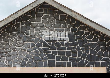close-up of gray and black stone wall design background texture, abstract of rocky dark masonry building facade surface pattern Stock Photo