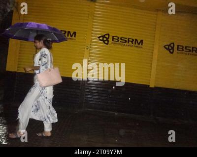 Dhaka, Bangladesh. 5th Oct, 2023. A woman walks during rain in Dhaka. The capital's daily life was reportedly disrupted by a continuous rain depression. (Credit Image: © MD Mehedi Hasan/ZUMA Press Wire) EDITORIAL USAGE ONLY! Not for Commercial USAGE! Stock Photo