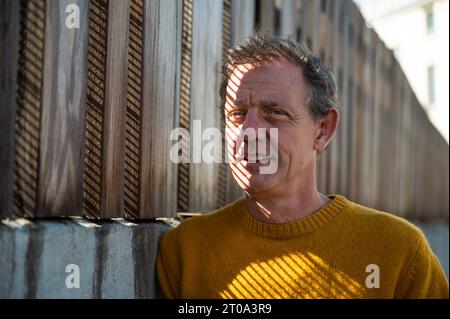 Portrait of a 55 yo white man, serious,and wearing a yellow sweater, Koekelberg, Brussels, Belgium Stock Photo