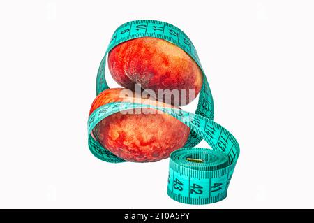Ripe peaches and measuring tape on white background, concept of healthy lifestyle, diet, overweight control. High quality photo Stock Photo