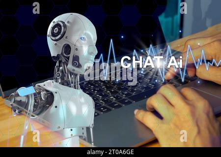 Chat Bot chats with AI or artificial intelligence technology. A person using a laptop computer is chatting with a smart artificial intelligence and as Stock Photo