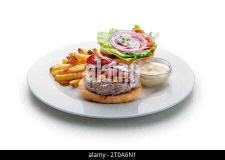 Burger with bacon, vegetables, cheese, dressing with fries Stock Photo