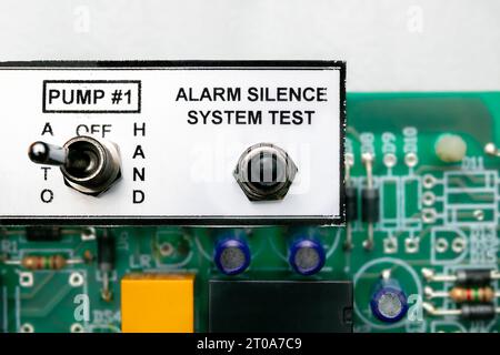 Pump  controller or pump system control panel, close up. Used in residential or commercial sump and sewage system. Focus on the alarm silence test swi Stock Photo