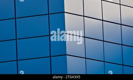 Abstract geometric rectanle background. Building facing exterior. Side light makes amazing blue structure. Stock Photo