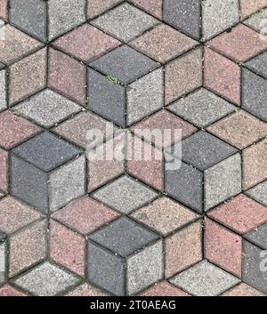 Seamless paving stone pavement texture in hexagonal geometric cube pattern. Dark grey, pink, and grey color. Pavement texture background. Landscape Stock Photo