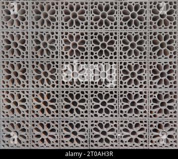 Close up pattern of moulded clay or ceramic latticework, or simply called as Roster, in flower pattern. Latticework is a moulded or cutout pattern Stock Photo