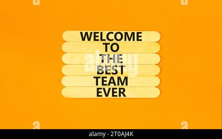 Welcome to best team symbol. Concept words Welcome to the best team ever on wooden stick on beautiful orange background. Business, motivational and we Stock Photo