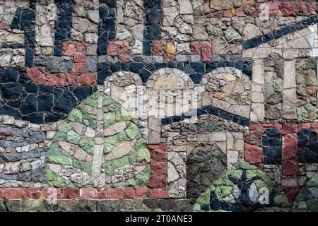Fragment of a wall made of stones of different colors for use as an abstract background and texture. Stock Photo