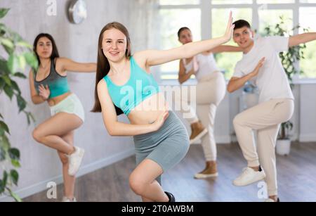 Teenagers practicing breakdance toprock moves in training hall. Teenagers engaged in breakdance Stock Photo