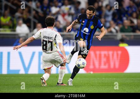 Hakan Calhanoglu of FC Internazionale competes for the ball with Joao Neves of SL Benfica during the UEFA Champions League football match between FC Internazionale and SL Benfica. Stock Photo