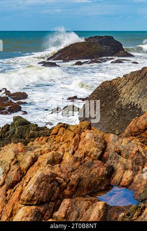 Waves crashing against the rocks in Serra Grande on the coast of the state of Bahia Stock Photo