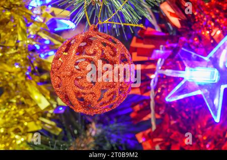 Bright star on the Christmas tree. Red Christmas decorations. New Year decorations and garlands Stock Photo