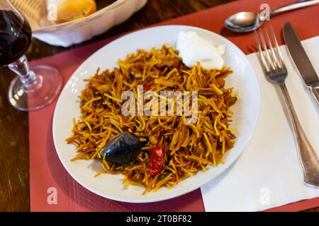 Traditional Valencian fideua de mariscos with sauce alioli Stock Photo