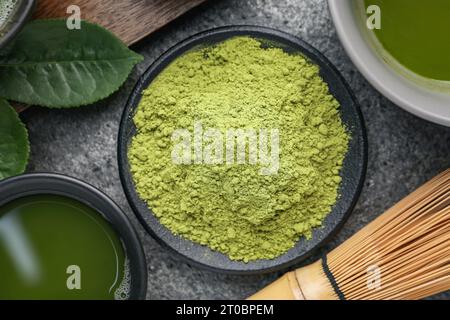 Flat lay composition with green matcha powder on grey table Stock Photo