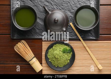 Flat lay composition with green matcha powder on wooden table Stock Photo