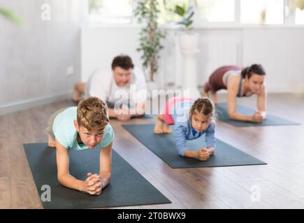 Mother daughter doing yoga in hi-res stock photography and images