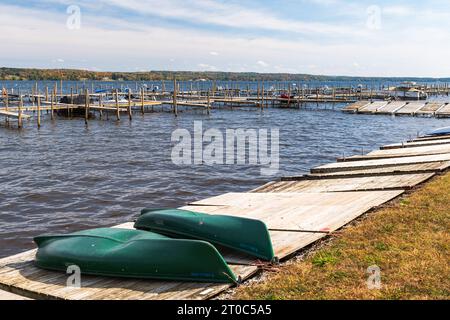 Two canoes turned upside down on a dock on Chautauqua Lake in Chautauqua Lake, New York, USA Stock Photo