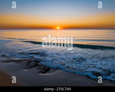 Sunrise seascape with clear skies at Shelly Beach on the Central Coast, NSW, Australia. Stock Photo