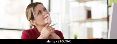 Thoughtful woman worker looks for new solutions in office Stock Photo