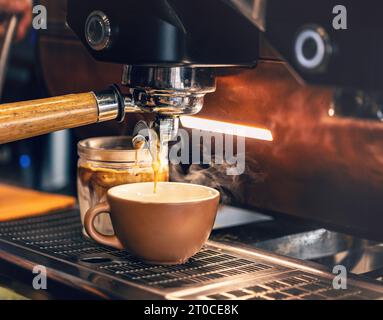 Coffee extraction from professional coffee machine with bottomless filter Stock Photo