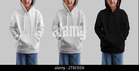 Mockup of white, heather, black hoodie for a girl, fashionable children's shirt, front view, isolated on background. A set of kid's apparel with a lon Stock Photo