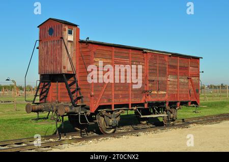 An original red wagon from the infamous 'Holocaust trains' at the Auschwitz Birkenau Concentration Camp. Poland, October 2012 Stock Photo