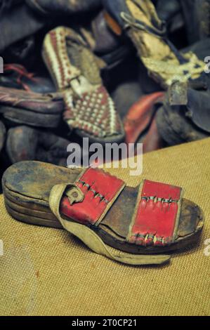Sandals and shoes of victims collected/confiscated by SS before extermination, on display at the museum in Auschwitz Birkenau, Poland, October 2012 Stock Photo