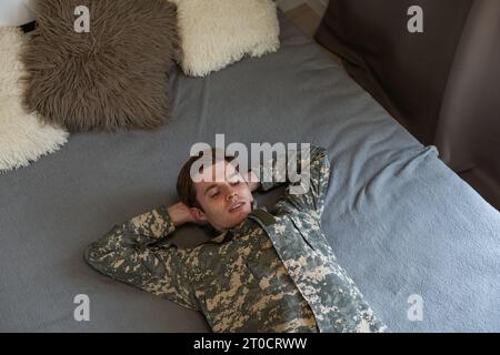 Young arab man wearing camouflage army uniform asking to be quiet with ...