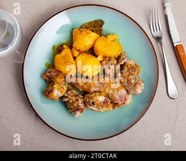 Braised rabbit served with potato garnish Stock Photo