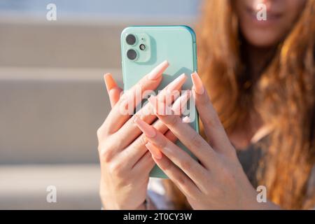 Close-up of woman's hands using a smartphone Stock Photo