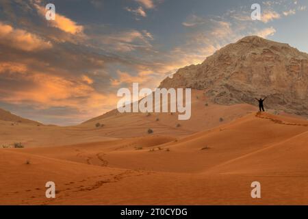 Breathtaking view of Dubai desert and dunes. People walking early morning in the desert Stock Photo