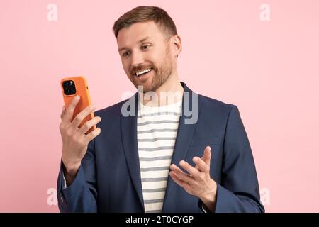 Overjoyed middle aged man laughing rejoicing at good offer approval of deal over isolated background Stock Photo