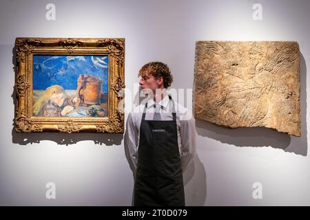 A gallery assistant views 'Clovis Endormi' by Paul Gaugin (Estimate £3,000,000 - £5,000,000) and 'An Assyrian Gypsum Releif of a Winged Genius' Region of Ashurnasirpal II, circa 883-859 BC (Estimated £2,500,00 - £5,000,000) during a photo call for Christie's 20th/21st Century: London Evening sale, on 13 October, the first in a series of sales dedicated to the scholarly vision of Sam Josefowitz. Picture date: Friday October 6, 2023. Stock Photo