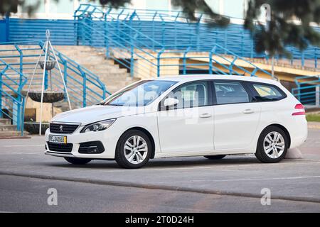 Berlin, Germany - May 28, 2023: Peugeot 308 SW station wagon version compact family car left side view outdoors parked on street. Stock Photo