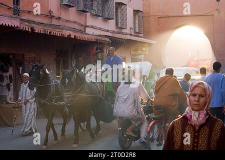 People and horse cart in a street at the Medina (old Town). Marrakesh, Morocco. Stock Photo