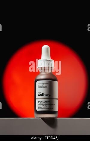 Strasbourg, France - September 2023: The Ordinary skincare brand by Deciem. AHA BHA Peeling Solution packaging against red moon. Clean minimalist high Stock Photo