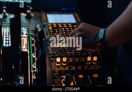 Close up view of the hands of a pilot at the cockpit Stock Photo