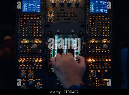 Hand of a pilot at the thrust levers of a jet Stock Photo