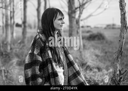 Balck and white portrait of mid adult woman in the countryside Stock Photo