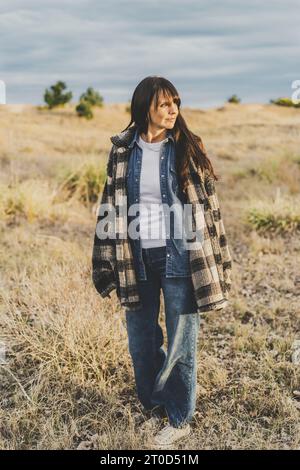 Portrait of mid mid-adult woman in the countryside, Vertical sho Stock Photo