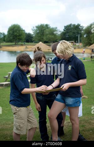 Secondary school pupils orienteering while on outward bound course Stock Photo