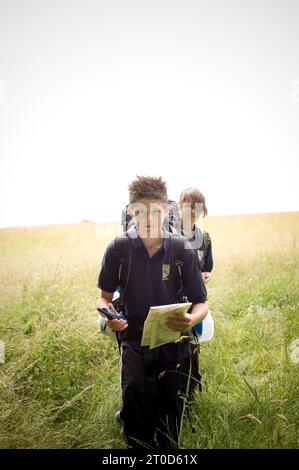 Secondary school pupils orienteering while on outward bound course Stock Photo