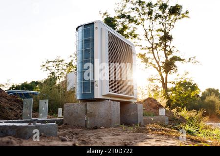 Heat pump outdoor unit in the afternoon sun Stock Photo