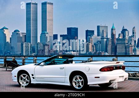 White Pontiac Firebird Trans Am 1999 convertible, series 4 model, parked in front of World Trade Centre skyline, New York, USA Stock Photo